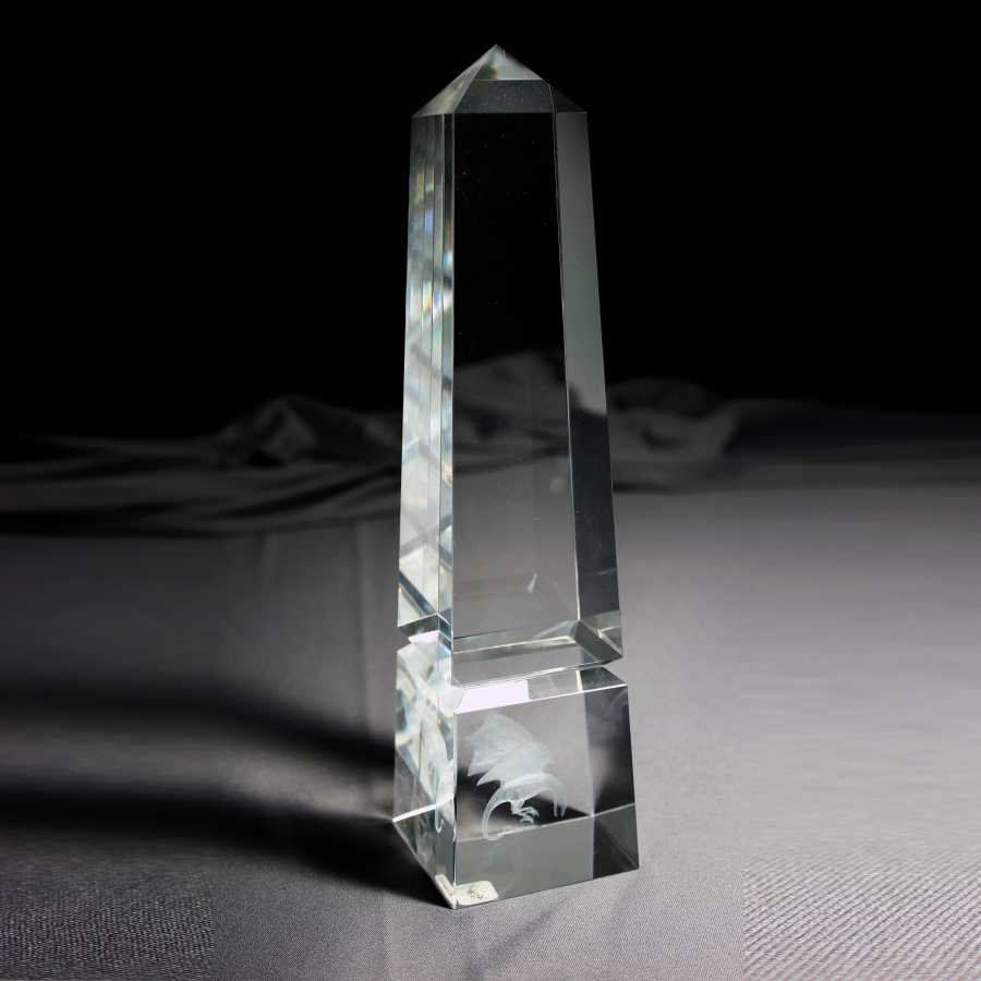 Custom crystal pillar monument award with 3-dimensional embedment