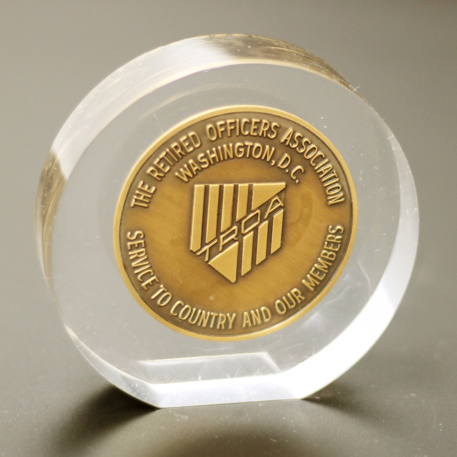 Die struck coin embedded within Lucite award