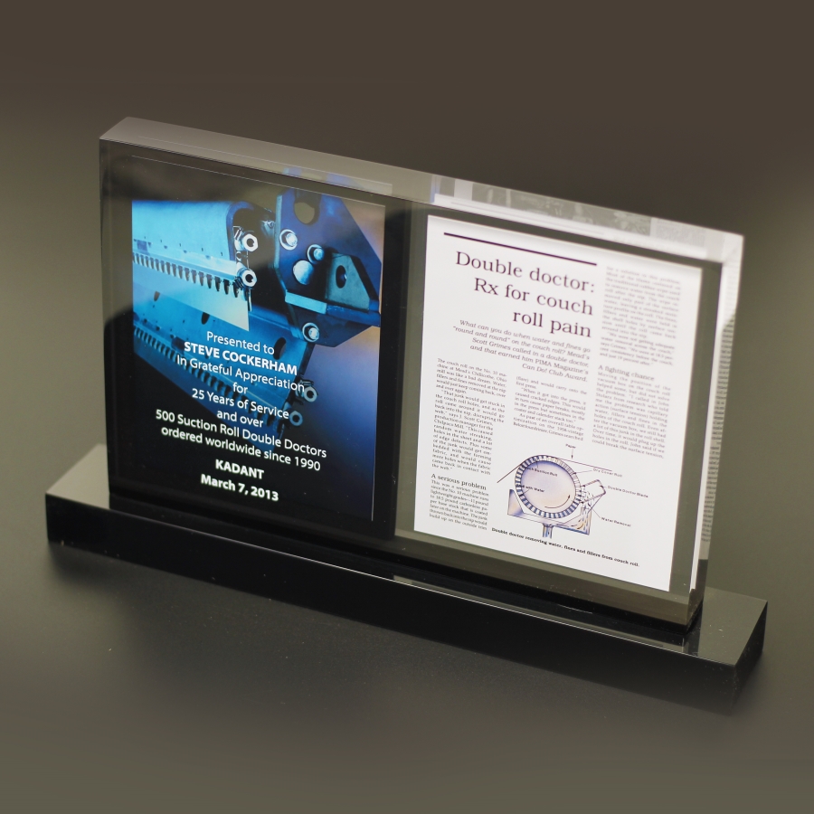 2-sided article embedded within Lucite display or award.