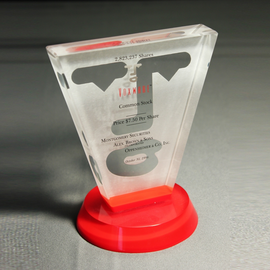 Custom triangle award made of Lucite on red base with embedment and etching  or could be printed